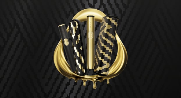 IQOS ILUMA i x Seletti and IQOS ILUMA i PRIME x Seletti Limited Edition devices in a golden IQOS logo